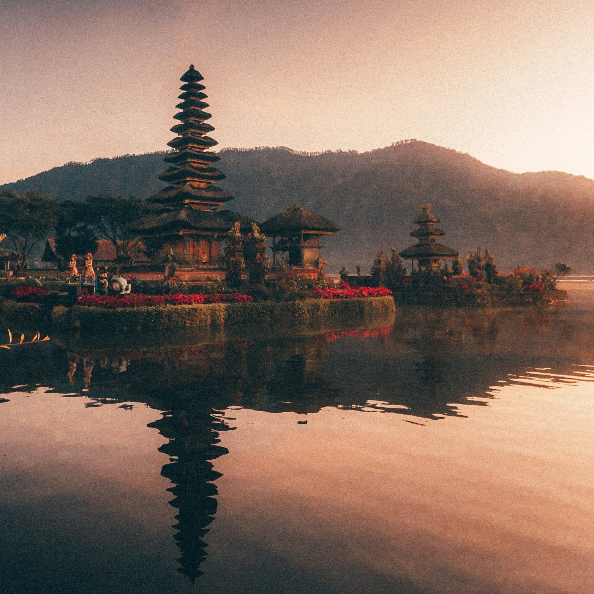 brown and black temple near body of water during daytime