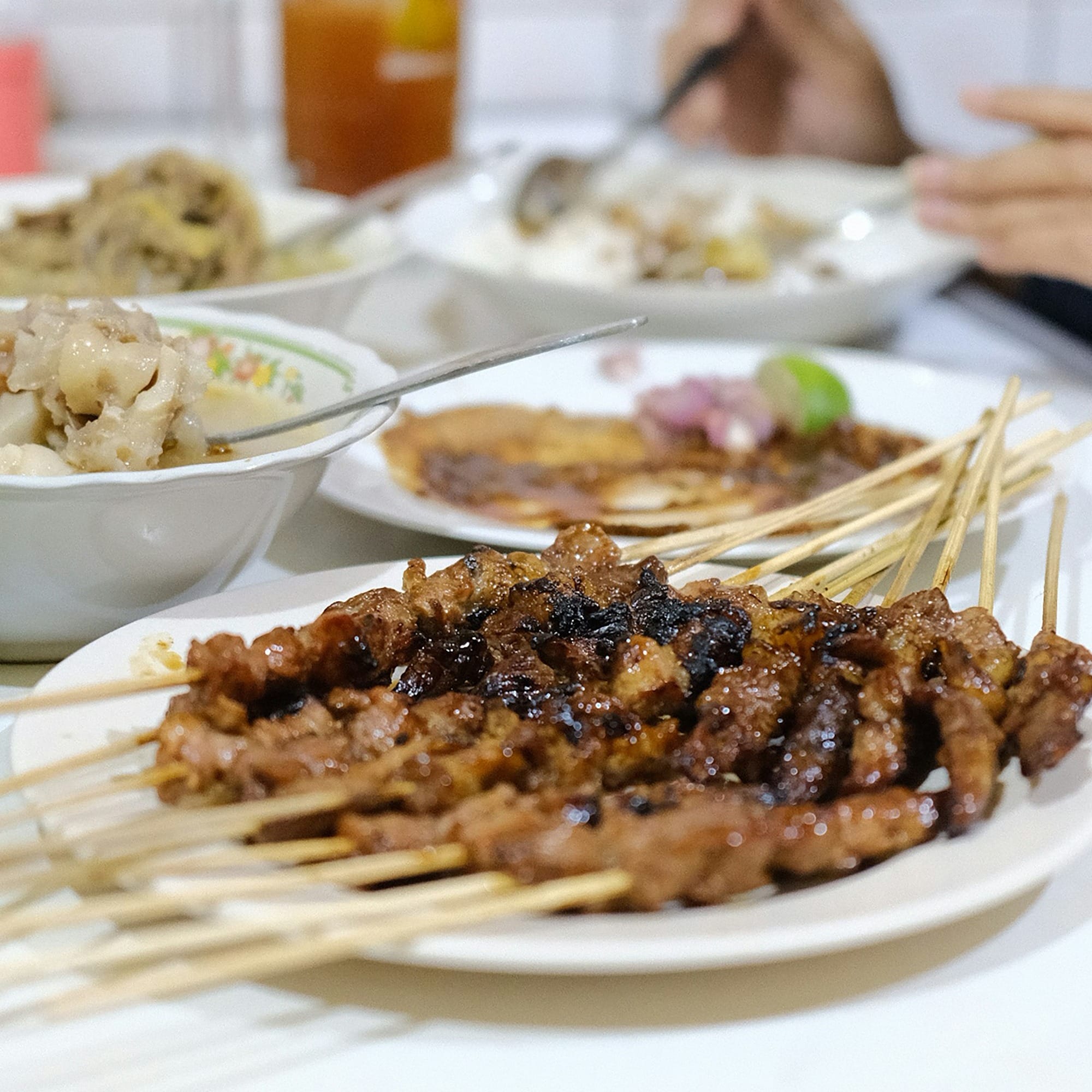 a table topped with plates of food covered in meat