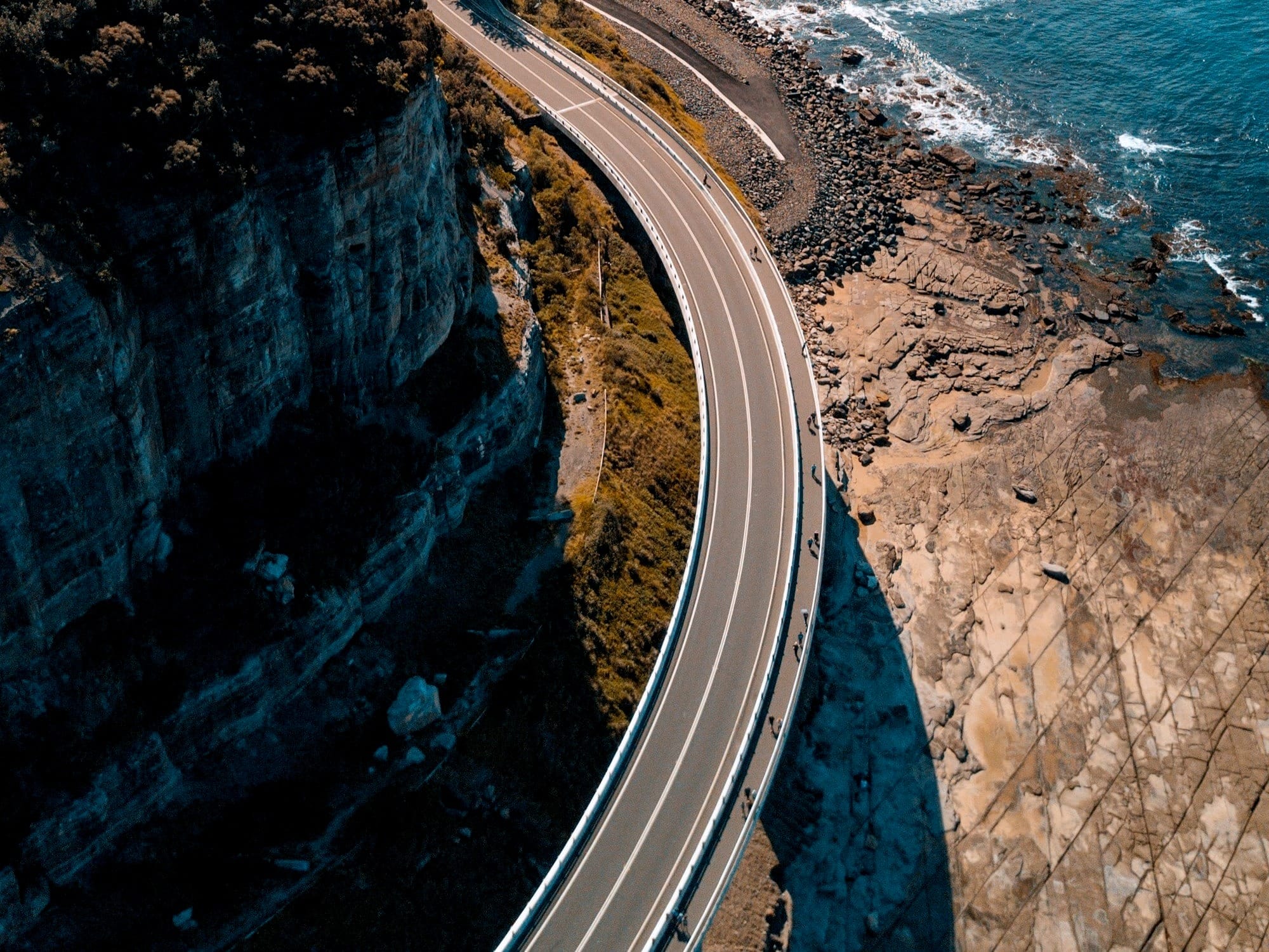 birds eye view of highway beside bay